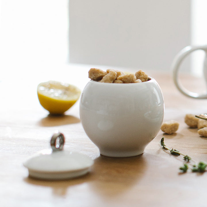 Glossy white ceramic creamer pitcher and sugar bowl set