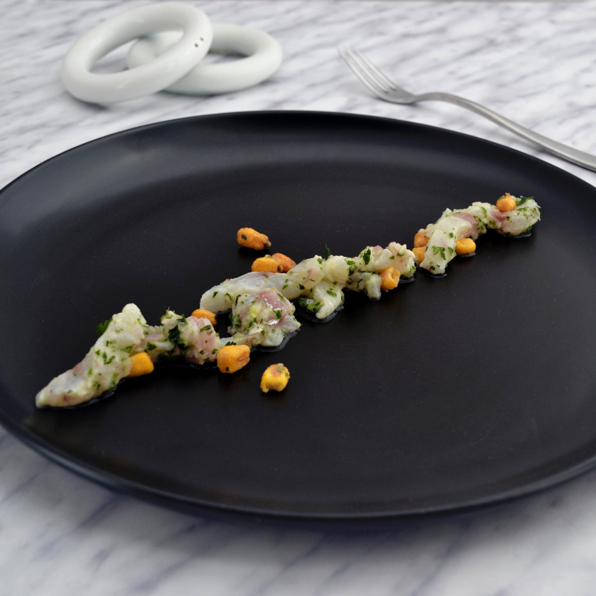 Matte black ceramic dinner plate with wide stoneware surface