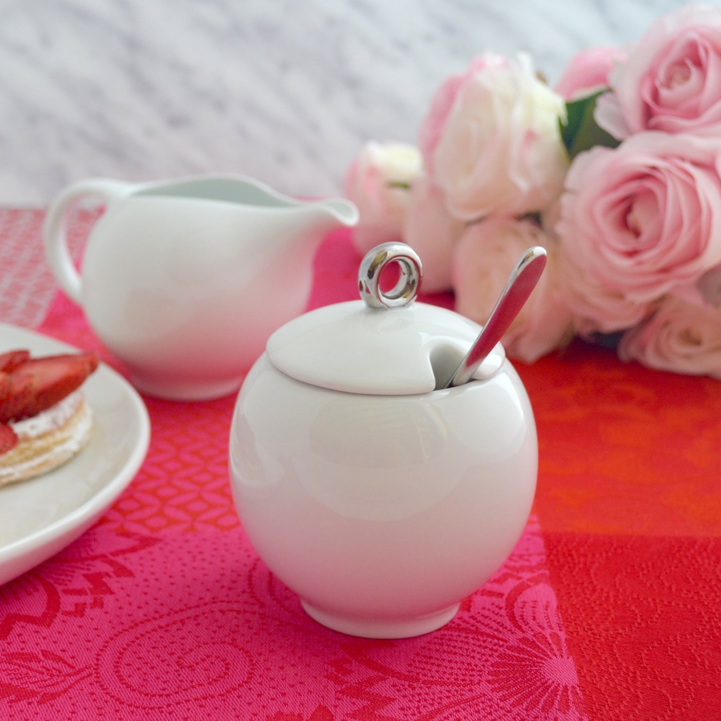 Glossy white ceramic creamer pitcher and sugar bowl set