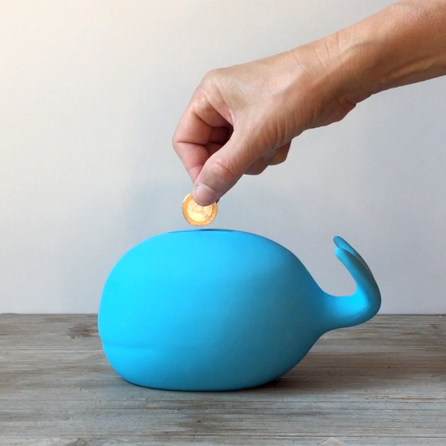 Blue whale piggy bank with ceramic body and coin slot