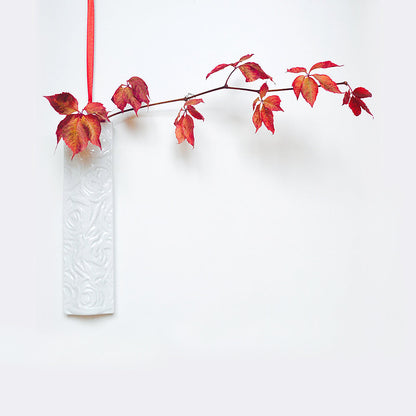 Porcelain hanging wall vase with engraved rose design