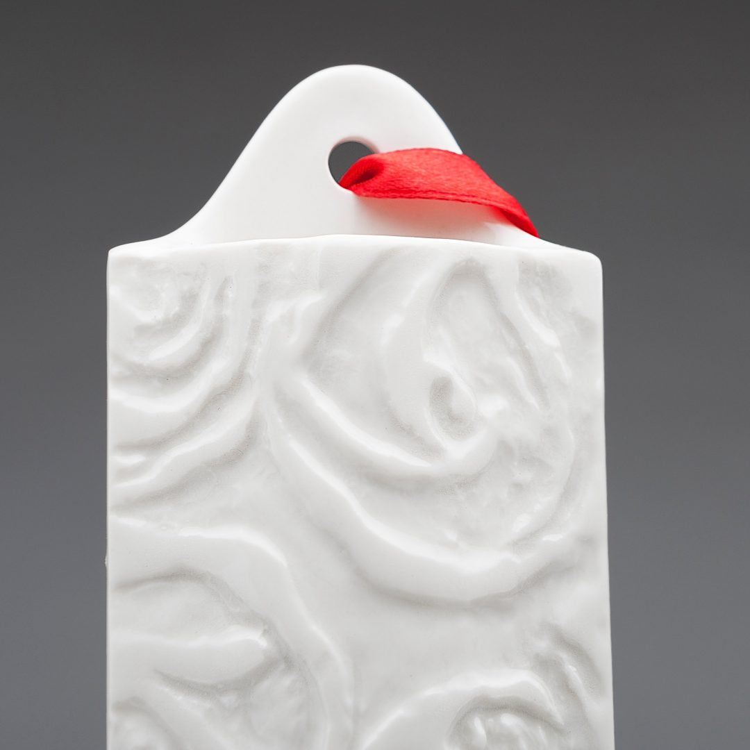 Porcelain hanging wall vase with engraved rose design