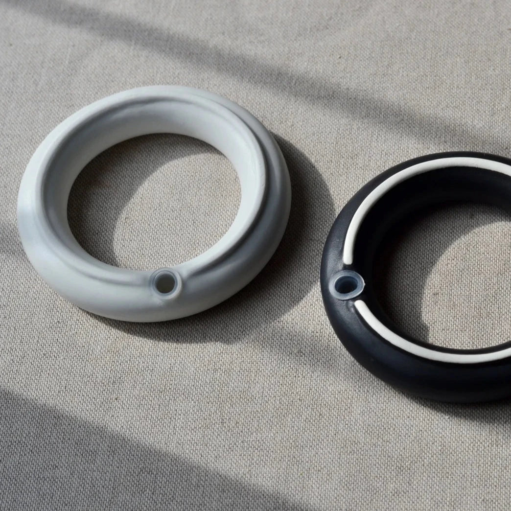 Detail showing silicone stopper underneath the Sculptural porcelain ring salt and pepper set by Maia Ming Designs, inspired by symbols of unity and commitment. High-fired and food-safe, this modern minimalist design makes an elegant wedding favour or anniversary gift for design-conscious couples.