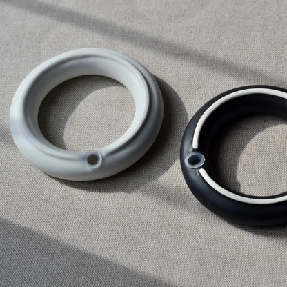 Detail showing silicone stopper underneath the Sculptural porcelain ring salt and pepper set by Maia Ming Designs, inspired by symbols of unity and commitment. High-fired and food-safe, this modern minimalist design makes an elegant wedding favour or anniversary gift for design-conscious couples.