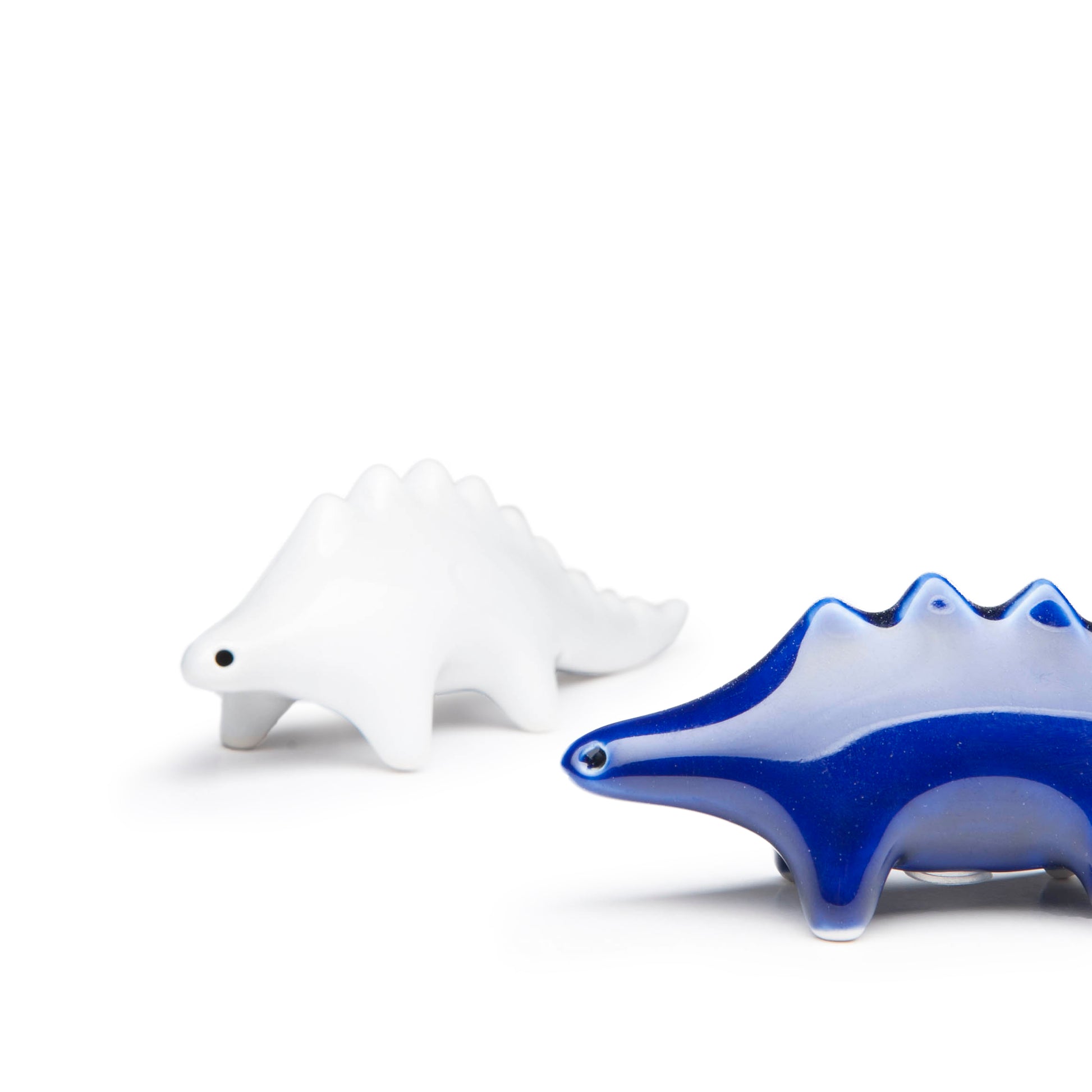 Whimsical dinosaur salt and pepper shakers in high-fired porcelain by Maia Ming Designs, modern minimalist sculptural design that invites you to play with your food. Food-safe artisan pottery handmade in Barcelona, a joyful accent for mindful daily rituals and design-forward interiors.