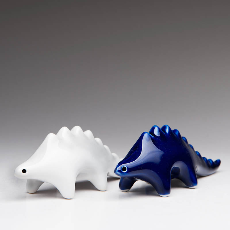 Whimsical dinosaur salt and pepper shakers in high-fired porcelain by Maia Ming Designs, modern minimalist sculptural design that invites you to play with your food. Food-safe artisan pottery , a joyful accent for mindful daily rituals and design-forward interiors.