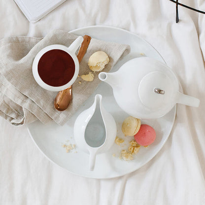 White porcelain Eva Zeisel teapot with mesh filter