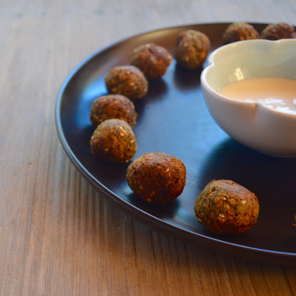Matte black ceramic dinner plate with wide stoneware surface
