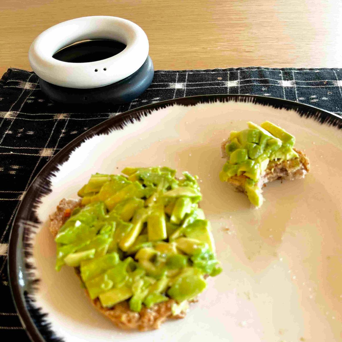 Avocado toast and Stackable ring salt and pepper shakers in designer-grade high-fired porcelain, a modern minimalist symbol of partnership. Handmade in Barcelona by Maia Ming Designs, food-safe artisan pottery created for shared meals and mindful daily rituals.