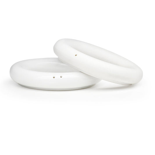 Modern minimalist ring-shaped salt and pepper shakers in high-fired porcelain by Maia Ming Designs, symbolizing commitment and partnership. Food-safe artisan pottery handmade in Barcelona, a meaningful wedding favour or thoughtful gift for shared daily rituals.